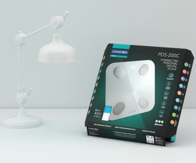 Black and green packaging of the PDS-200C Personal Digital Scale on a table, next to a lamp